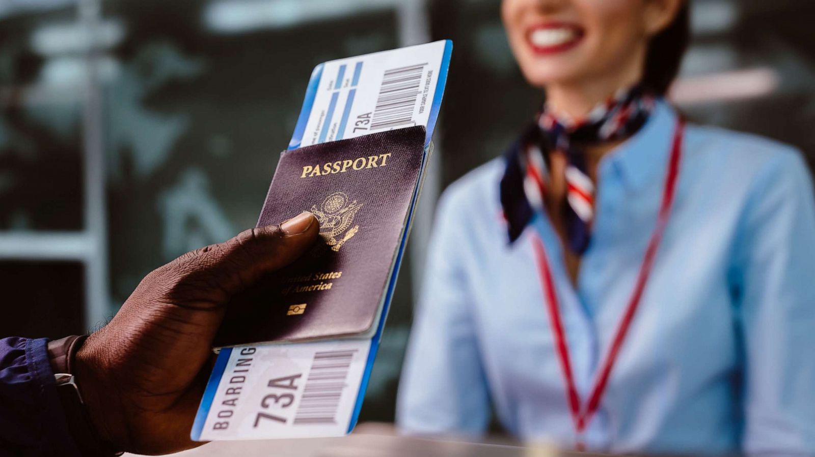 PHOTO: In this undated file photo, a man holds a boarding pass and a passport at an airline check-in desk.