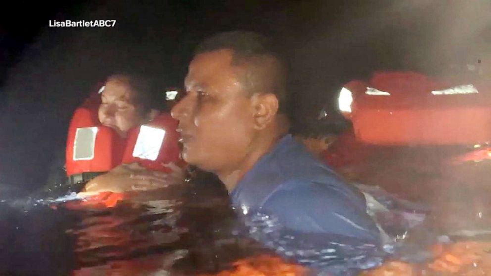 PHOTO: Passengers swim in shark-infested waters in the Galapagos Islands to flee a fire on their boat.