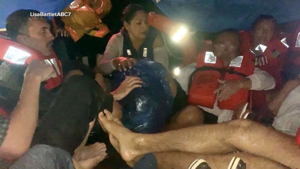 PHOTO: Passengers swim in shark-infested waters in the Galapagos Islands to flee a fire on their boat.