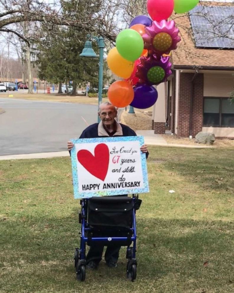 PHOTO: Man holds sign for his wife outside of nursing home for their 67th anniversary after they ban visitors due to coronavirus