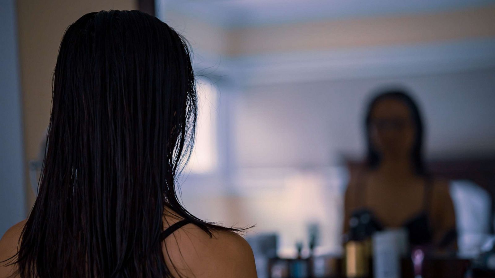 PHOTO: A woman looks at her reflection in a mirror in an undated stock image.