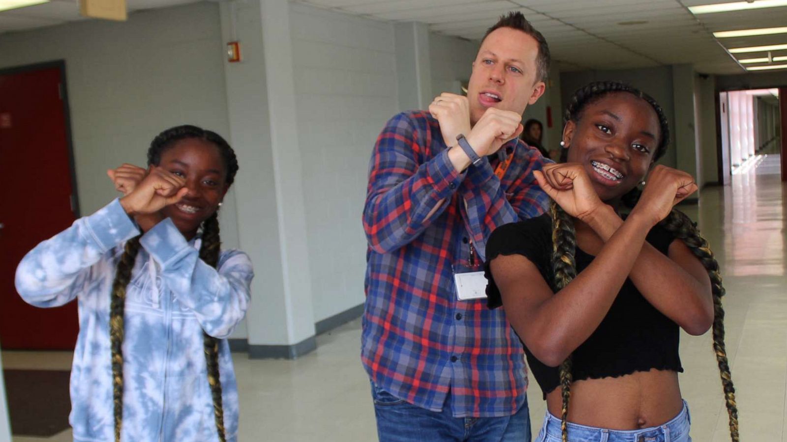 PHOTO: Dr. Trevor Boffone, a Spanish teacher at Bellaire High School in Bellaire, Texas, dances with his students, Takia and Talia Palmer.