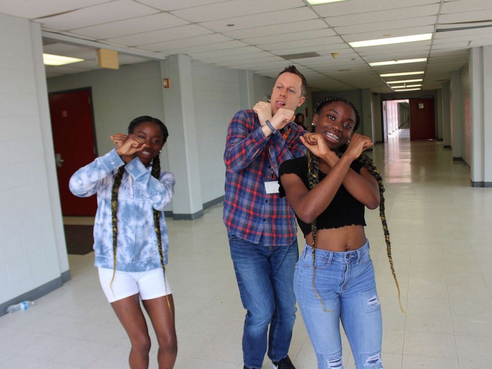 PHOTO: Dr. Trevor Boffone, a Spanish teacher at Bellaire High School in Bellaire, Texas, dances with his students, Takia and Talia Palmer.