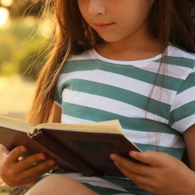 PHOTO: A girl reads a book in an undated stock photo. 