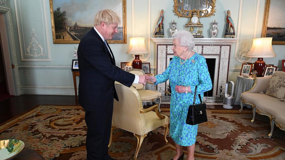 PHOTO: In this July 24, 2019, file photo, Queen Elizabeth II welcomes newly elected leader of the Conservative party, Boris Johnson at Buckingham Palace in London.