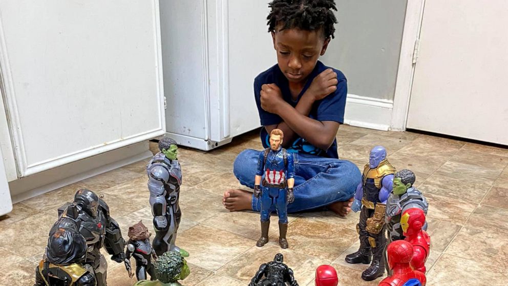 PHOTO: Carter, 5, of Greenville, South Carolina, puts up the "Wakanda Forever" pose in front of his action figures in tribute of Chadwick Boseman's character following his passing.