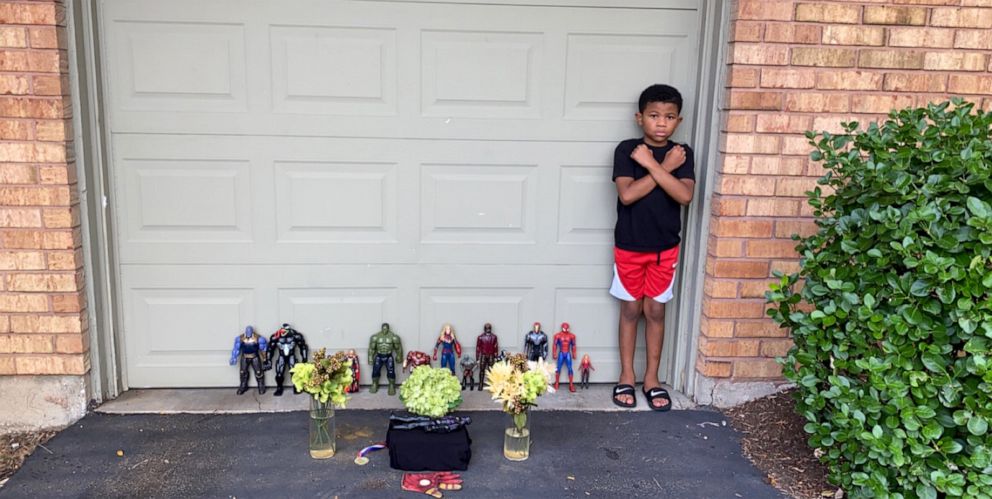PHOTO: Kian, a 7-year-old "Black Panther" fan in St. Louis, Missouri, holds a memorial after the death of the film's star, Chadwick Boseman.