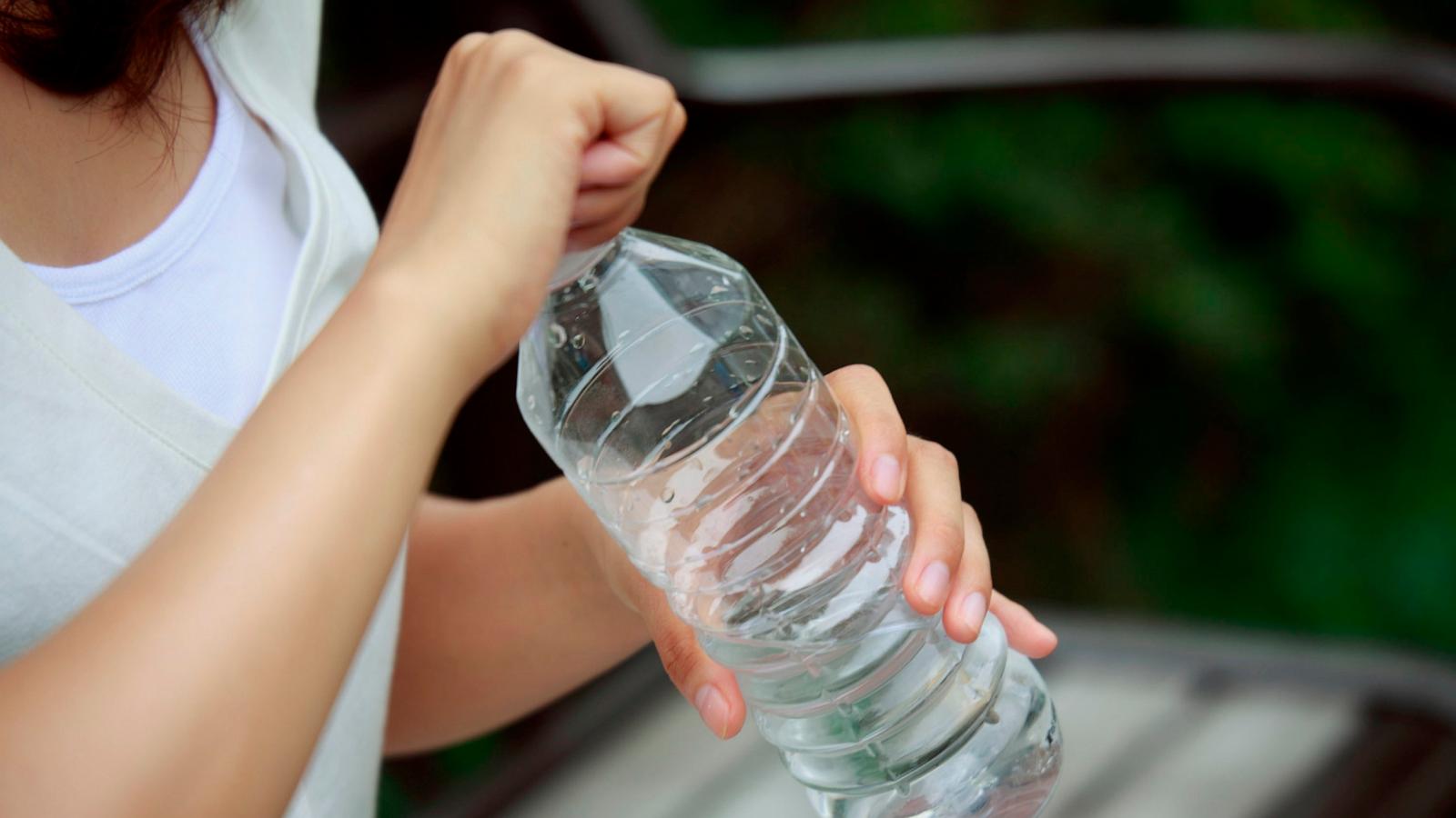 PHOTO: In this undated stock photo, a woman is seen unscrewing a plastic water bottle.