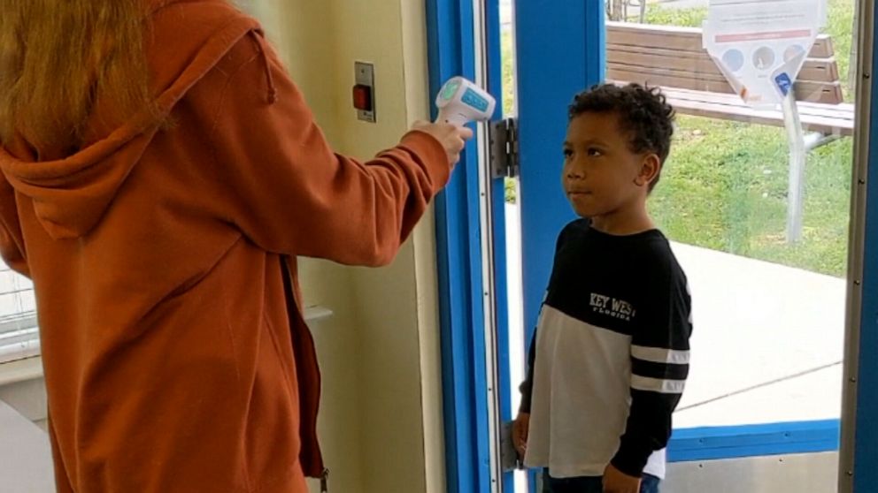 PHOTO: An essential worker drops her child off at a Boys and Girls Club in Edgewood, Maryland.