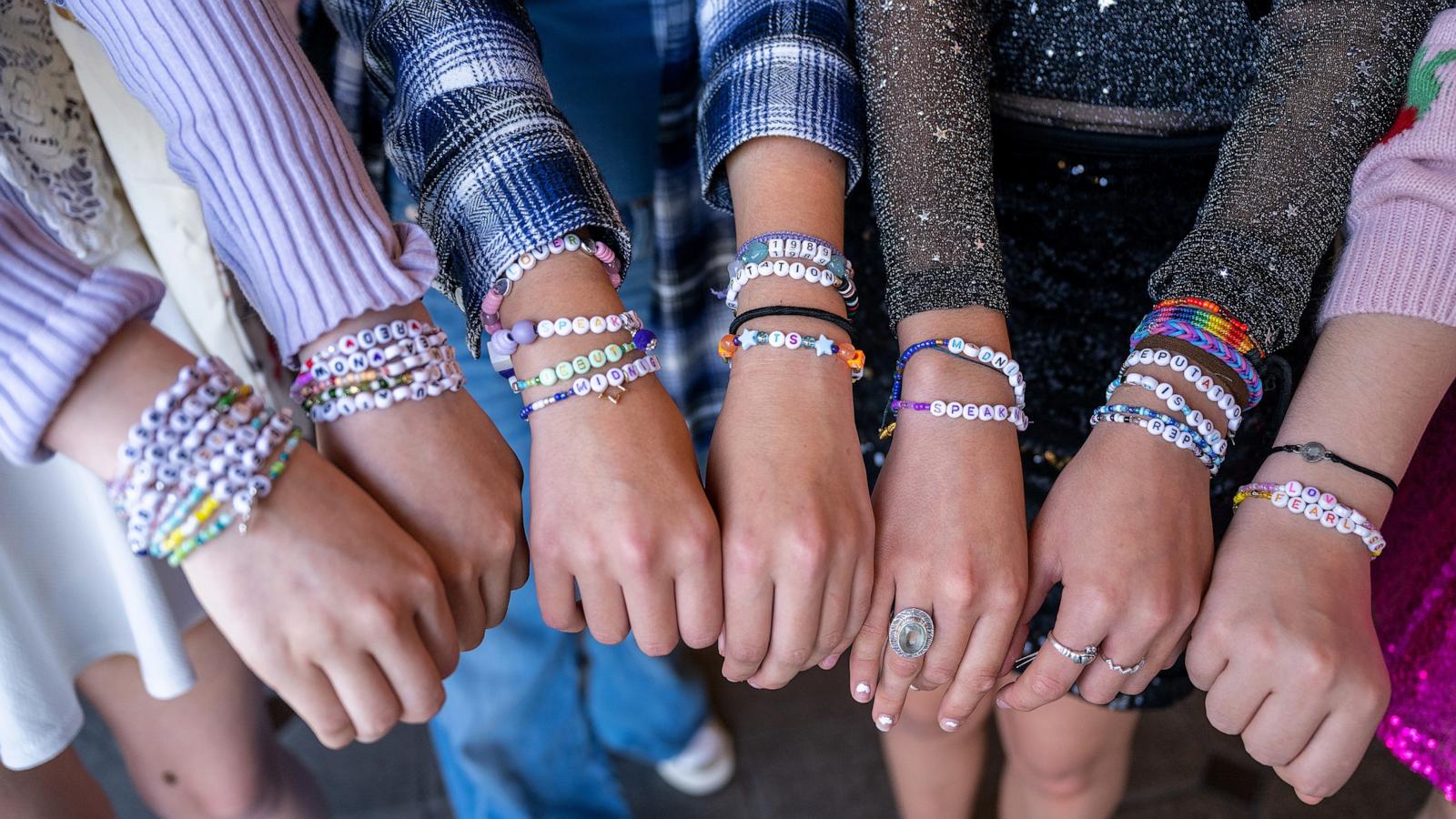 PHOTO: Taylor Swift fans, friendship bracelet detail, attend the opening night theatrical release of "Taylor Swift : The Eras Tour" at AMC Marina Marketplace 6 on Oct. 13, 2023 in Marina del Rey, Calif.