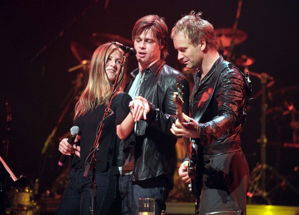 PHOTO: Jennifer Aniston and Brad Pitt show off Jennifer's engagement ring onstage at the Beacon Theater in New York during a Sting concert on Nov. 21, 1999. 