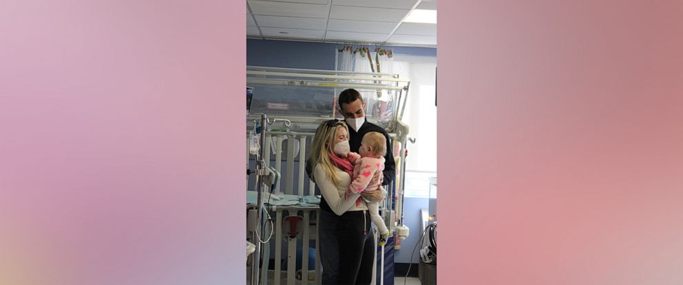 PHOTO: Darlene and James Foster hold their daughter Bradi before she was discharged from Franciscan Children's in Boston.