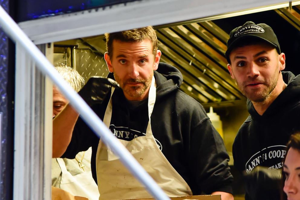 PHOTO: Bradley Cooper works inside the Danny & Coop's Cheesesteaks food truck on Dec. 6, 2023 in New York City. 