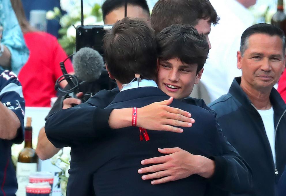 PHOTO: Tom Brady hugs his son Jack at his Patriots Hall of Fame induction ceremony at Gillette Stadium in Foxborough, Mass., June 12, 2024.