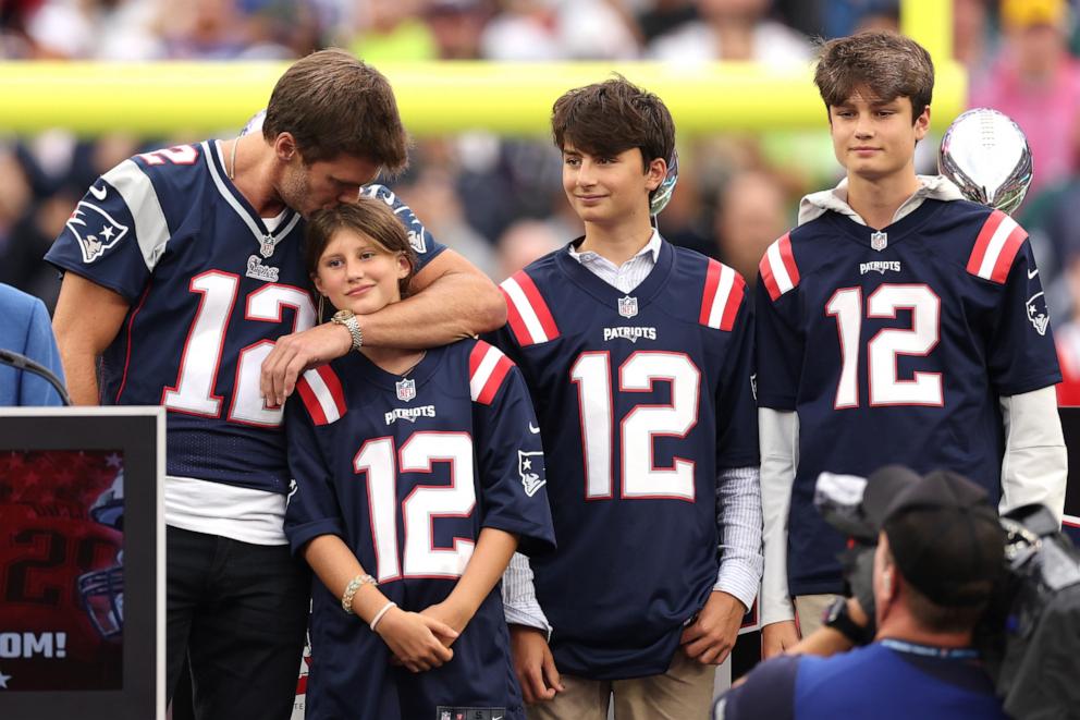 PHOTO: Tom Brady kisses his daughter, Vivian, while his sons, Benjamin and Jack, look on during a ceremony honoring Brady at halftime of New England's game against the Philadelphia Eagles at Gillette Stadium on Sept. 10, 2023 in Foxborough, Mass.