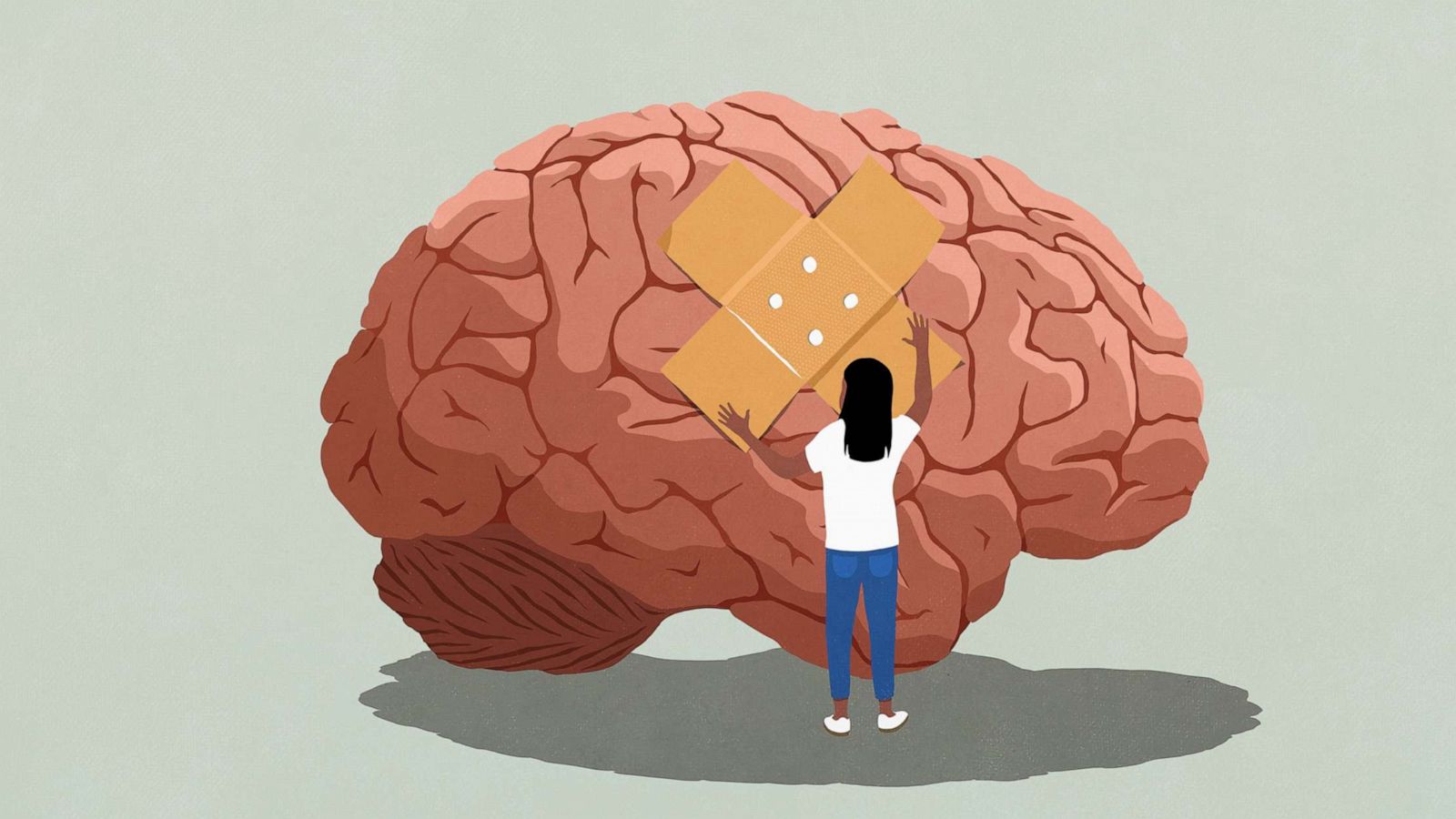 PHOTO: A photo illustration shows a woman putting a bandaid on a brain. Mental Health stock photo.