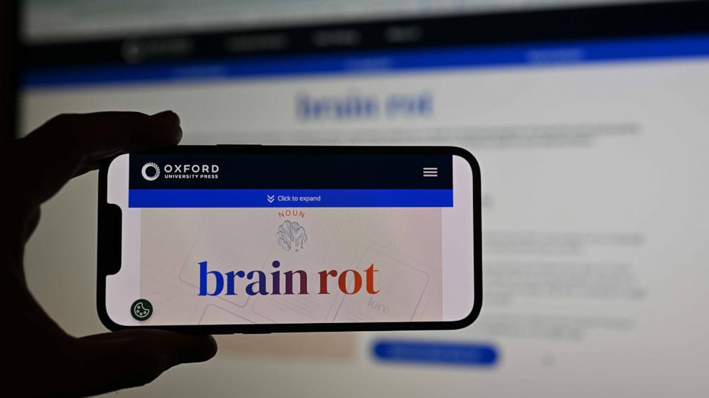 PHOTO: A man holds a phone, displaying word of ''brain rot'', as the Oxford Dictionary has chosen the word, which refers to the unnecessary and entertaining use of social media, as the word of the year in London, Dec. 2, 2024.