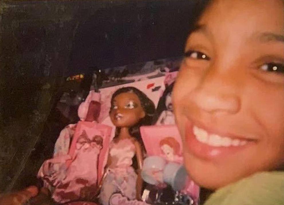 PHOTO: Lyric Mariah Heard posing with her Sasha Bratz doll as a child. She says Bratz were her favorite dolls since you need to pop off the foot to change the shoe, just like her.