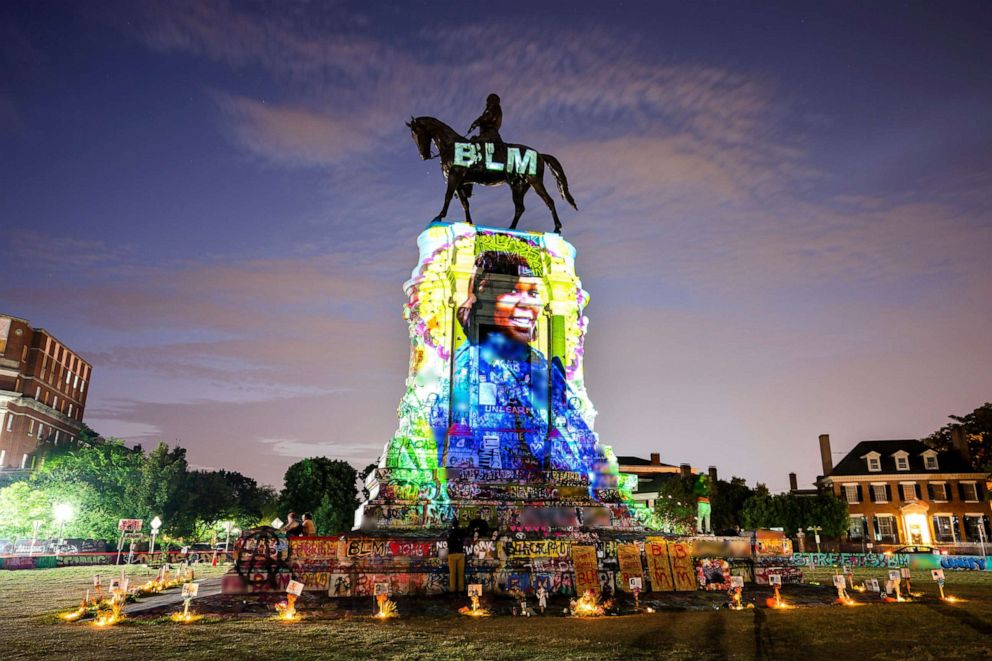 PHOTO: A photograph of Breonna Taylor, who was killed in her own apartment by Louisville, Kentucky police officers, is projected onto a statue of Confederate General Robert E. Lee in Richmond, Va., July 6, 2020. 