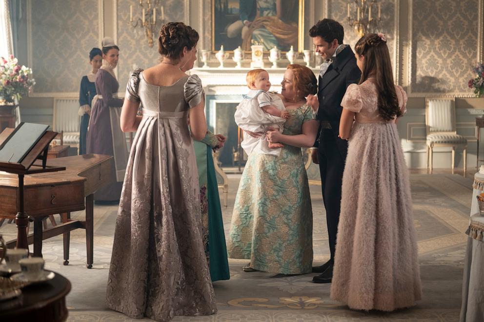 PHOTO: Sophie Lamont as Celia, Ruth Gemmell as Lady Violet Bridgerton, Polly Walker as Lady Featherington, Nicola Coughlan as Penelope Featherington, Luke Thompson as Benedict Bridgerton, and Florence Hunt as Hyacinth Bridgerton in Bridgerton Season 4.