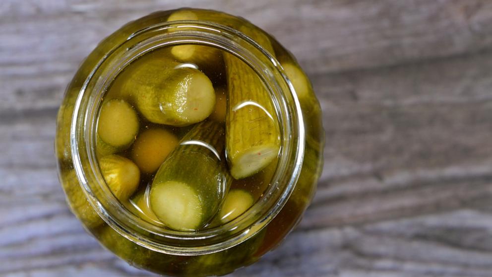 PHOTO: Brine in a glass and jar of pickled cucumbers in an undated photo