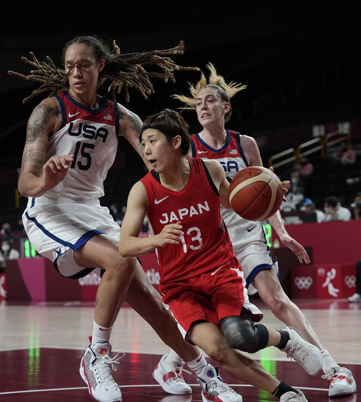 PHOTO: Japan's Rui Machida (13) drives around United States's Brittney Griner (15) and Breanna Stewart (10), right, during the women's basketball gold medal game at the 2020 Summer Olympics, Aug. 8, 2021, in Saitama, Japan.