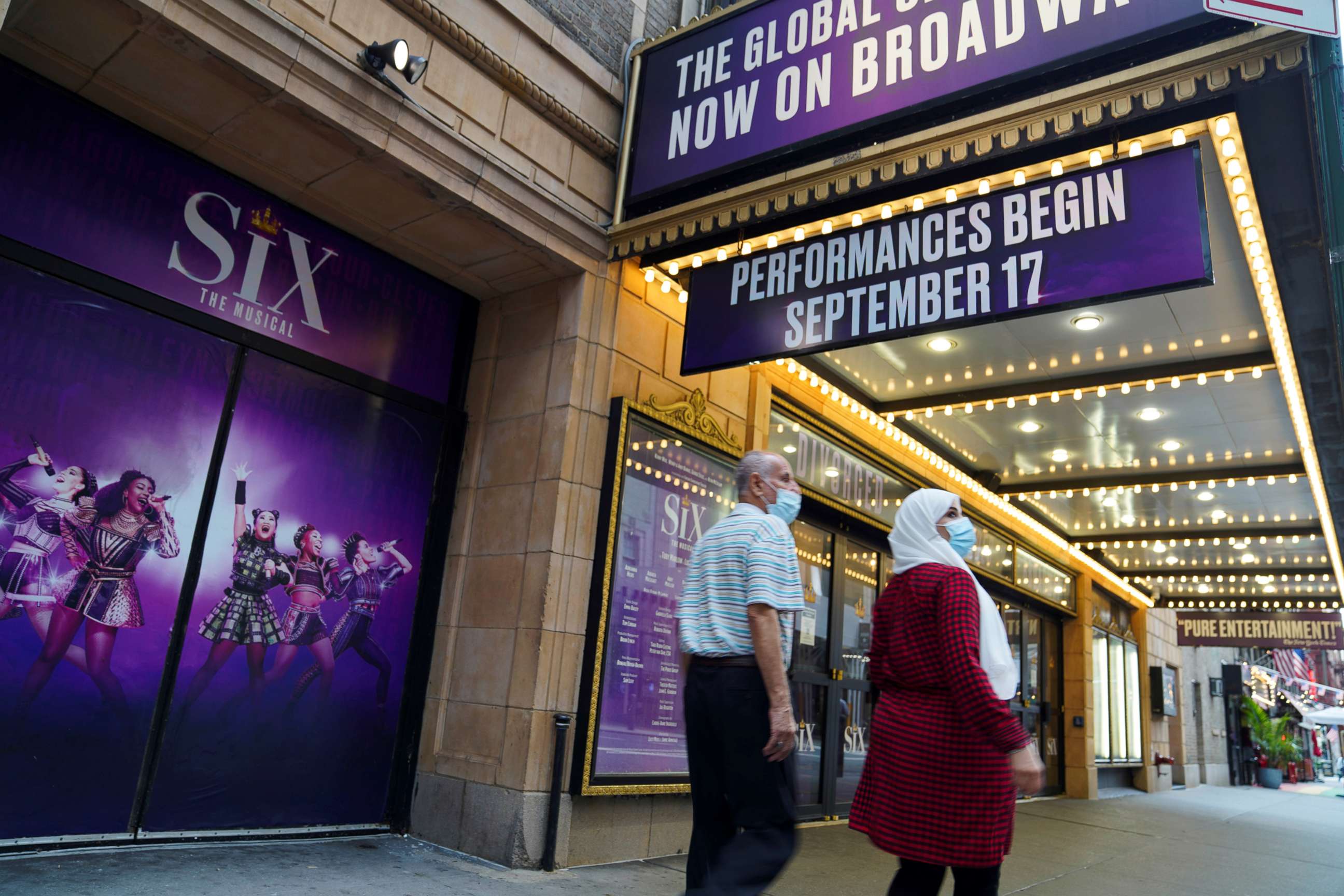 PHOTO: Pedestrians walk past a Broadway theater in New York, July 2, 2021.