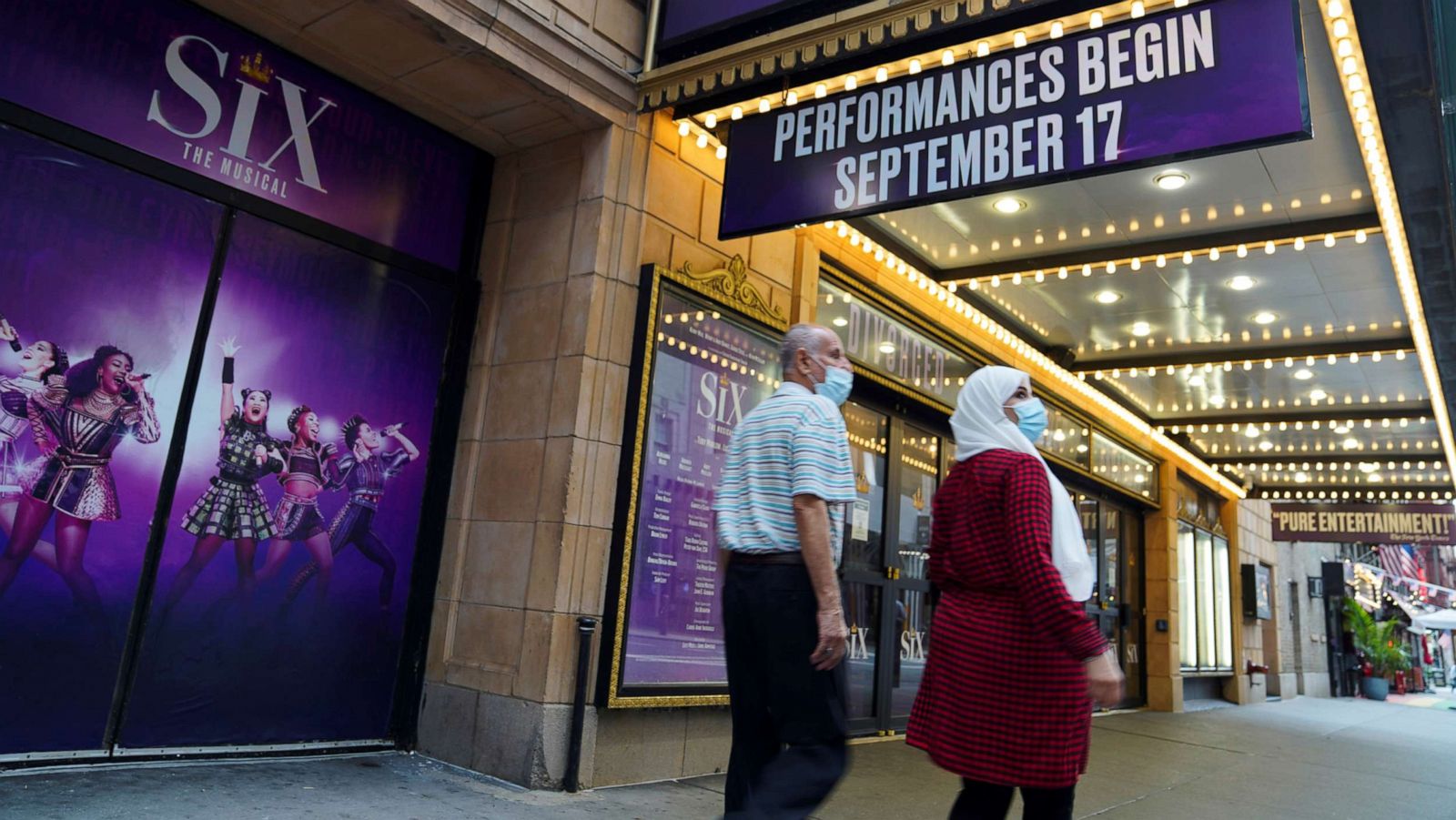 PHOTO: Pedestrians walk past a Broadway theater in New York, July 2, 2021.