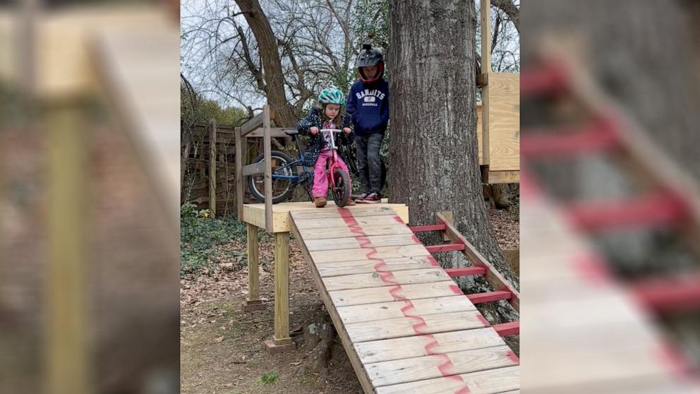 PHOTO: An older brother teaches his sister how to bike down a ramp, Feb. 2024, in Greenville, S.C.