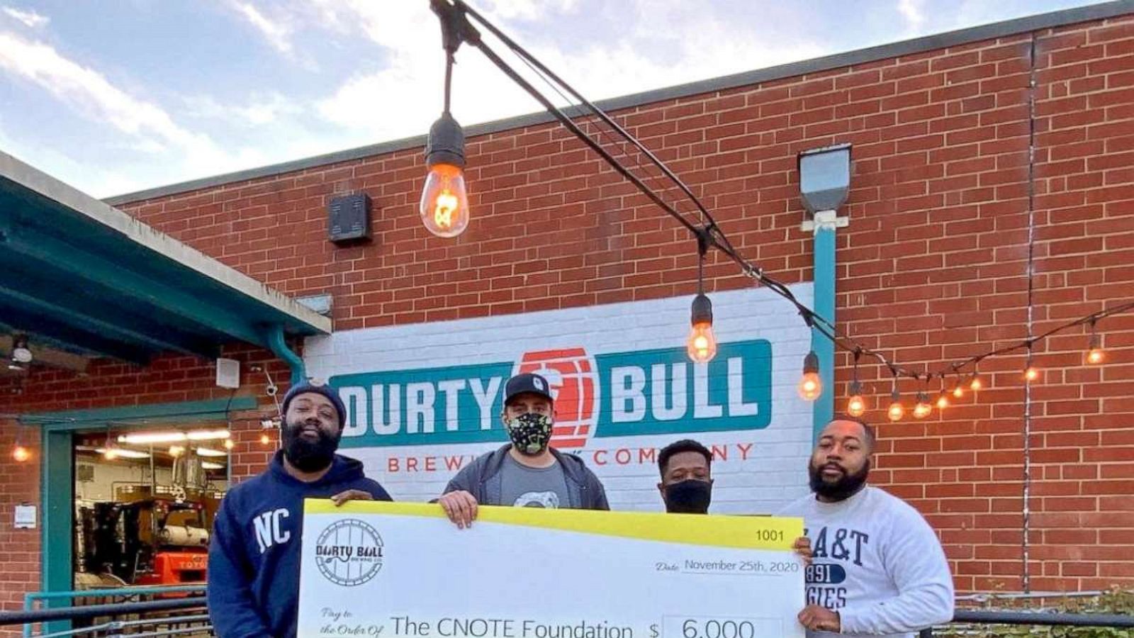 PHOTO: The Collins brothers pose with a $6,000 check for their endowment at the North Carolina Agricultural & Technical State University.