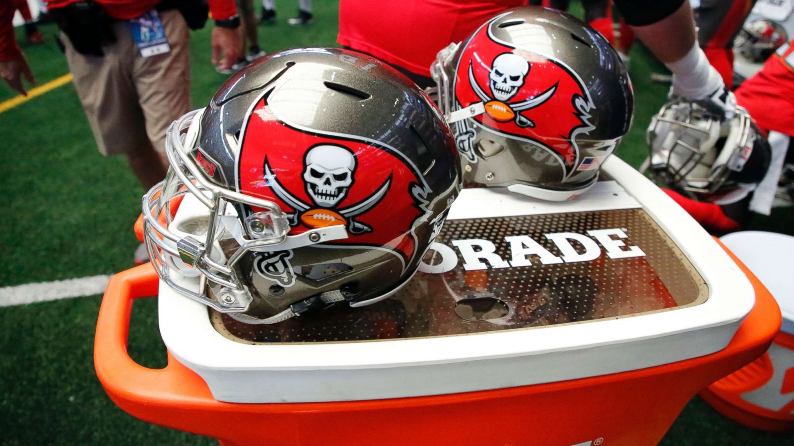 PHOTO: Tampa Bay Buccaneers helmets sit on a Gatorade cooler on the sideline during an NFL football game against the Dallas Cowboys, Dec. 23, 2018, in Arlington, Texas.