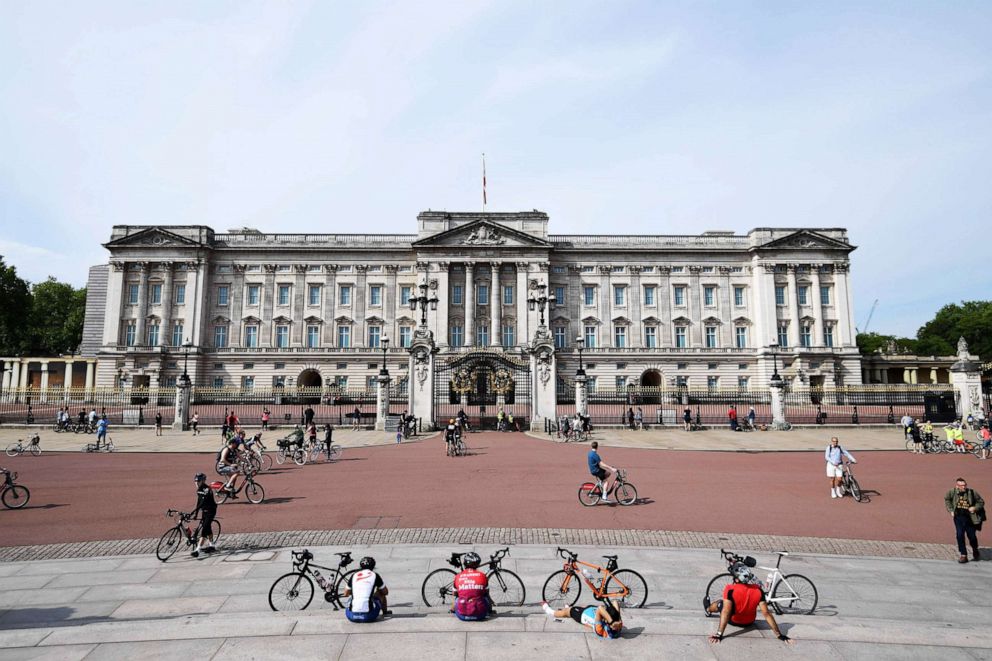 PHOTO: Cyclists rest in front of Buckingham Palace in London, May 8, 2020.