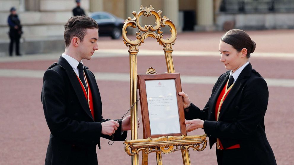 PHOTO: Members of staff set up an official notice on an easel at the gates of Buckingham Palace in London on May 6, 2019 announcing the birth of a son to Britain's Prince Harry, Duke of Sussex and Meghan, Duchess of Sussex.