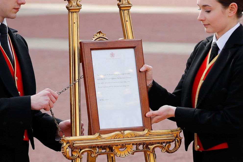 PHOTO: Members of staff set up an official notice on an easel at the gates of Buckingham Palace in London on May 6, 2019 announcing the birth of a son to Britain's Prince Harry, Duke of Sussex and Meghan, Duchess of Sussex.