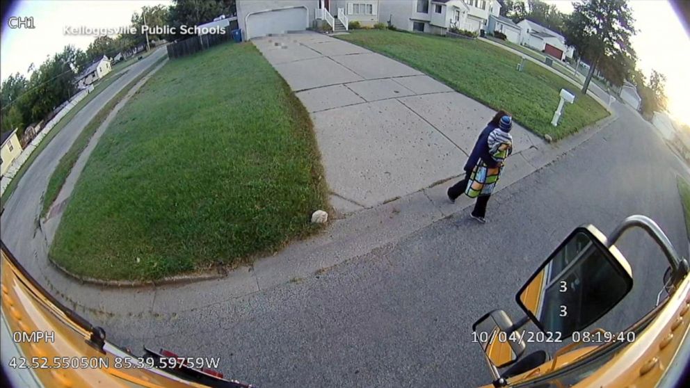 PHOTO: In surveillance video, Sue Figueroa, a school bus driver in Michigan, is seen carrying a toddler who had been left on the side of the road, into her bus.