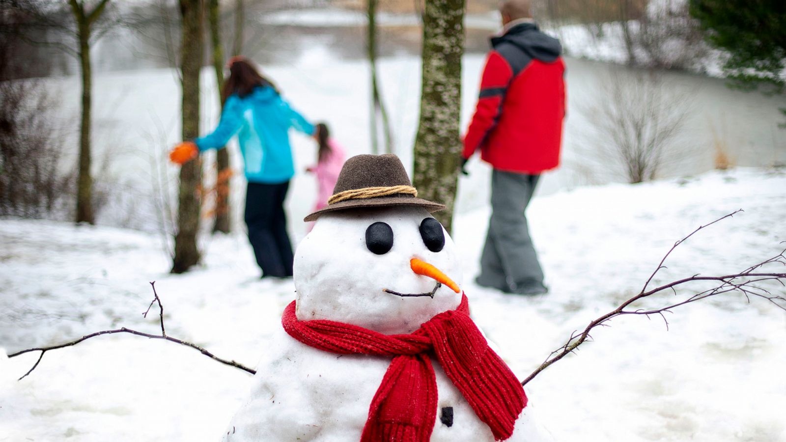 PHOTO: A family walks behind a snowman they built in an undated stock image.