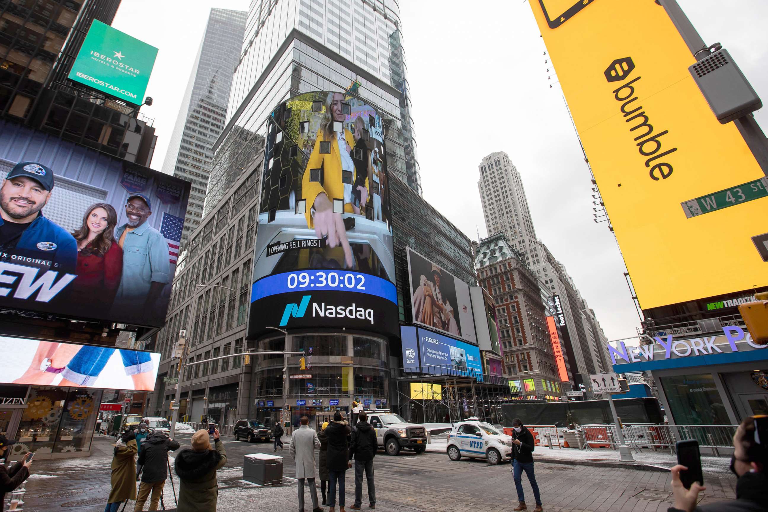 PHOTO: A monitor displays Whitney Wolfe Herd, chief executive officer of Bumble Inc., ringing the opening bell during Bumble Inc.'s initial public offering (IPO) in front of the Nasdaq Market Site in New York, Feb. 11, 2021. 