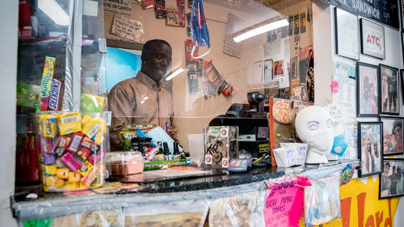 PHOTO: Burnell Cotlon, owner of Burnell's Lower Ninth Ward Market works behind the register in New Orleans on April 14, 2020.