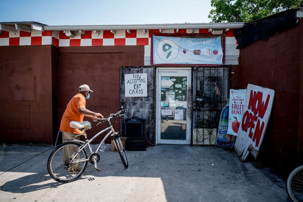 PHOTO: A customer enters Burnell's Lower Ninth Ward Market in New Orleans, April 14, 2020.
