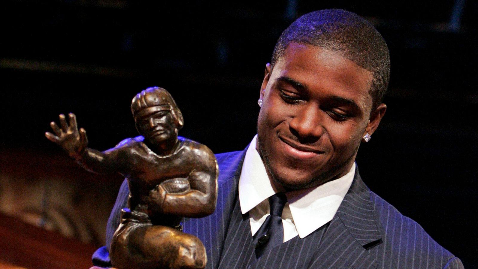 PHOTO: In this Dec. 10, 2005 file photo Southern California tailback Reggie Bush picks up the Heisman Trophy after being announced as the winner of the award in New York.