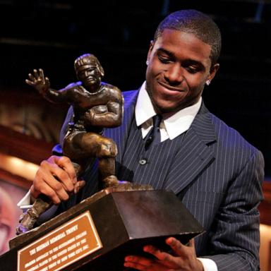 PHOTO: In this Dec. 10, 2005 file photo Southern California tailback Reggie Bush picks up the Heisman Trophy after being announced as the winner of the award in New York.