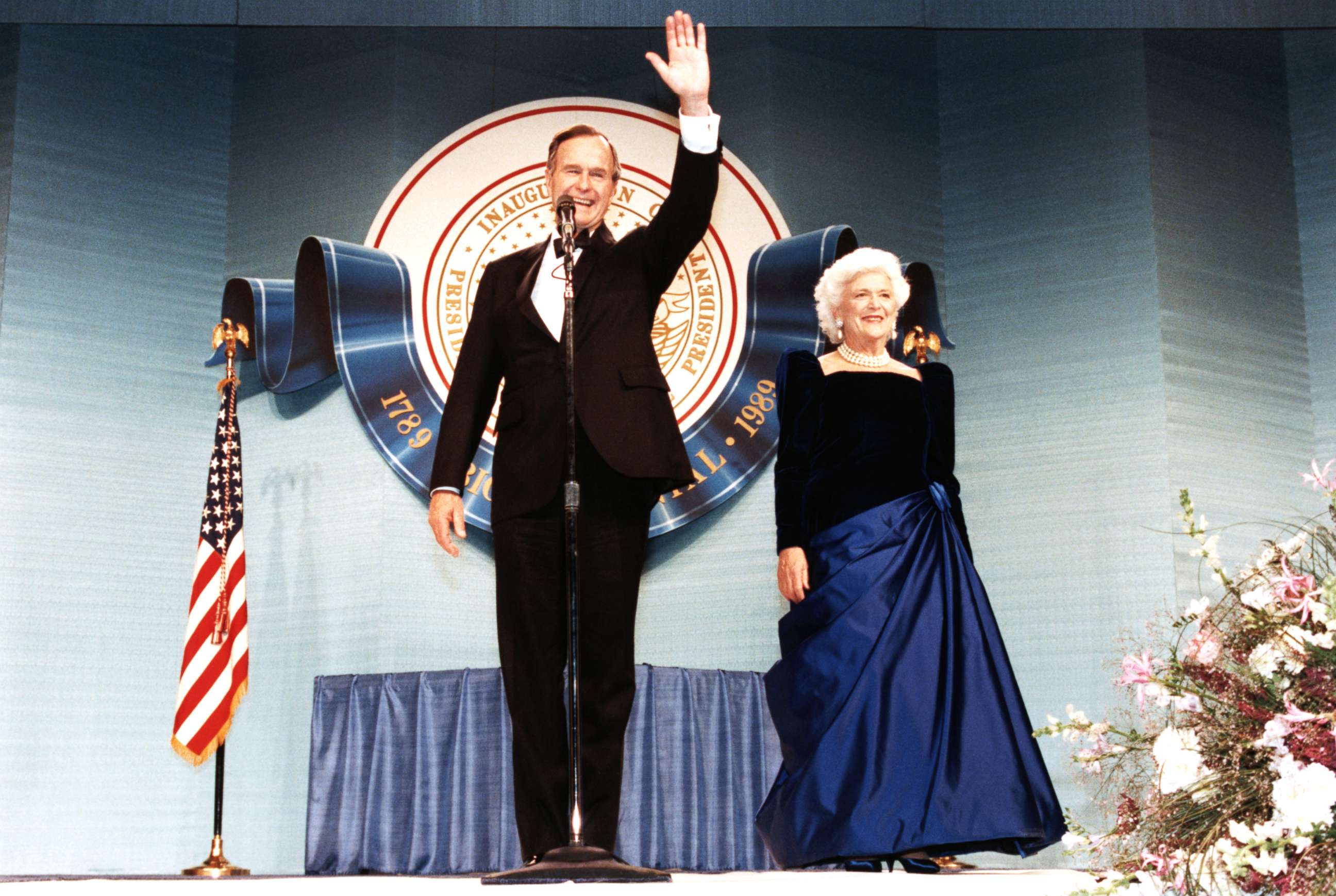 PHOTO: George Bush smiles and waves to participants of his inaugural celebration with his wife Barbara in Washington D.C., Jan. 20, 1989.