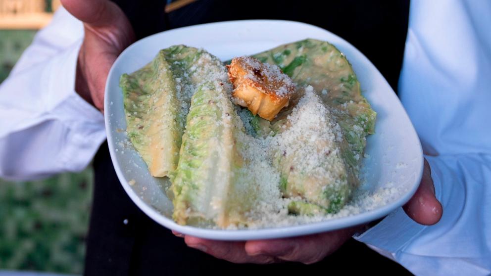 PHOTO: Salad Master Efrain Montoya poses holding a Caesar salad at Ceasar's restaurant, June 27, 2024, in Tijuana, Mexico. 