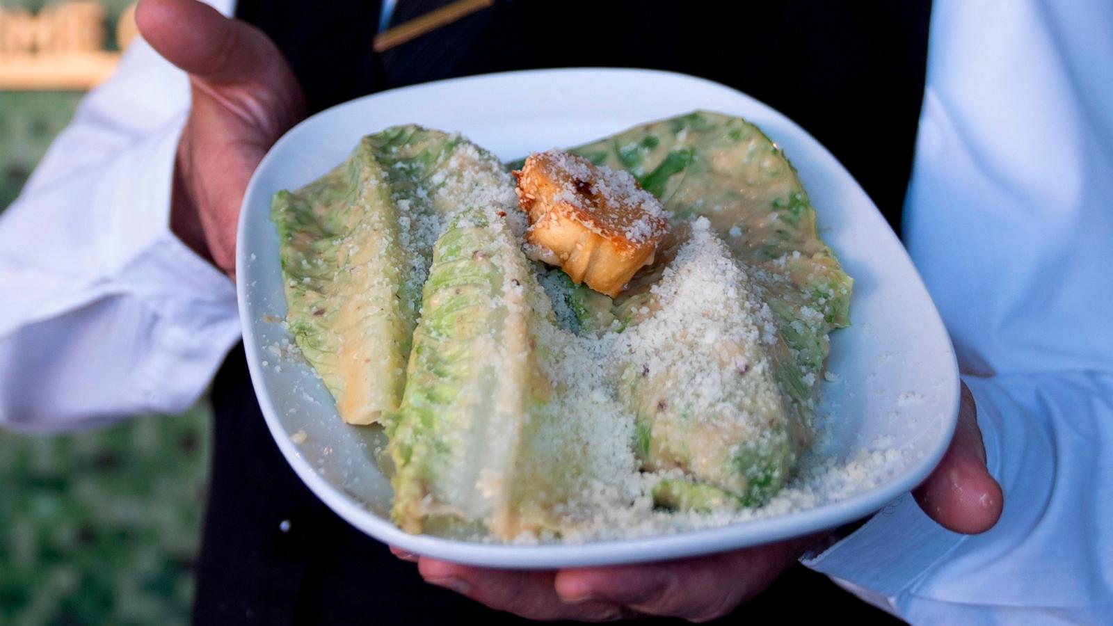 PHOTO: Salad Master Efrain Montoya poses holding a Caesar salad at Ceasar's restaurant, June 27, 2024, in Tijuana, Mexico.