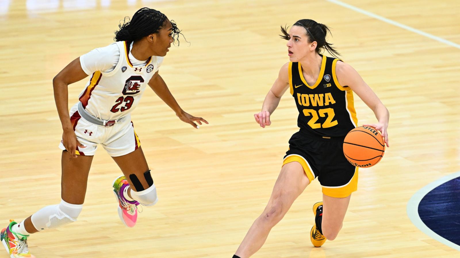 PHOTO: Caitlin Clark #22 of the Iowa Hawkeyes dribbles around Bree Hall #23 of the S.C. Gamecocks during the 2024 NCAA Women's Basketball Tournament National Championship at Rocket Mortgage FieldHouse April 07, 2024 in Cleveland, Ohio.