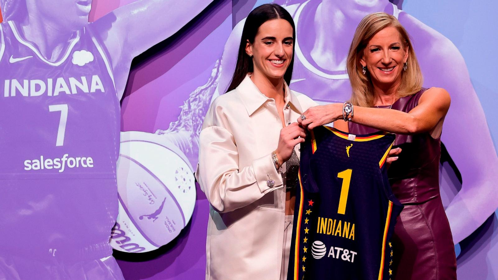 PHOTO: Iowa's Caitlin Clark, left, poses for a photo with WNBA commissioner Cathy Engelbert, right, after being selected first overall by the Indiana Fever during the first round of the WNBA basketball draft, April 15, 2024, in New York.