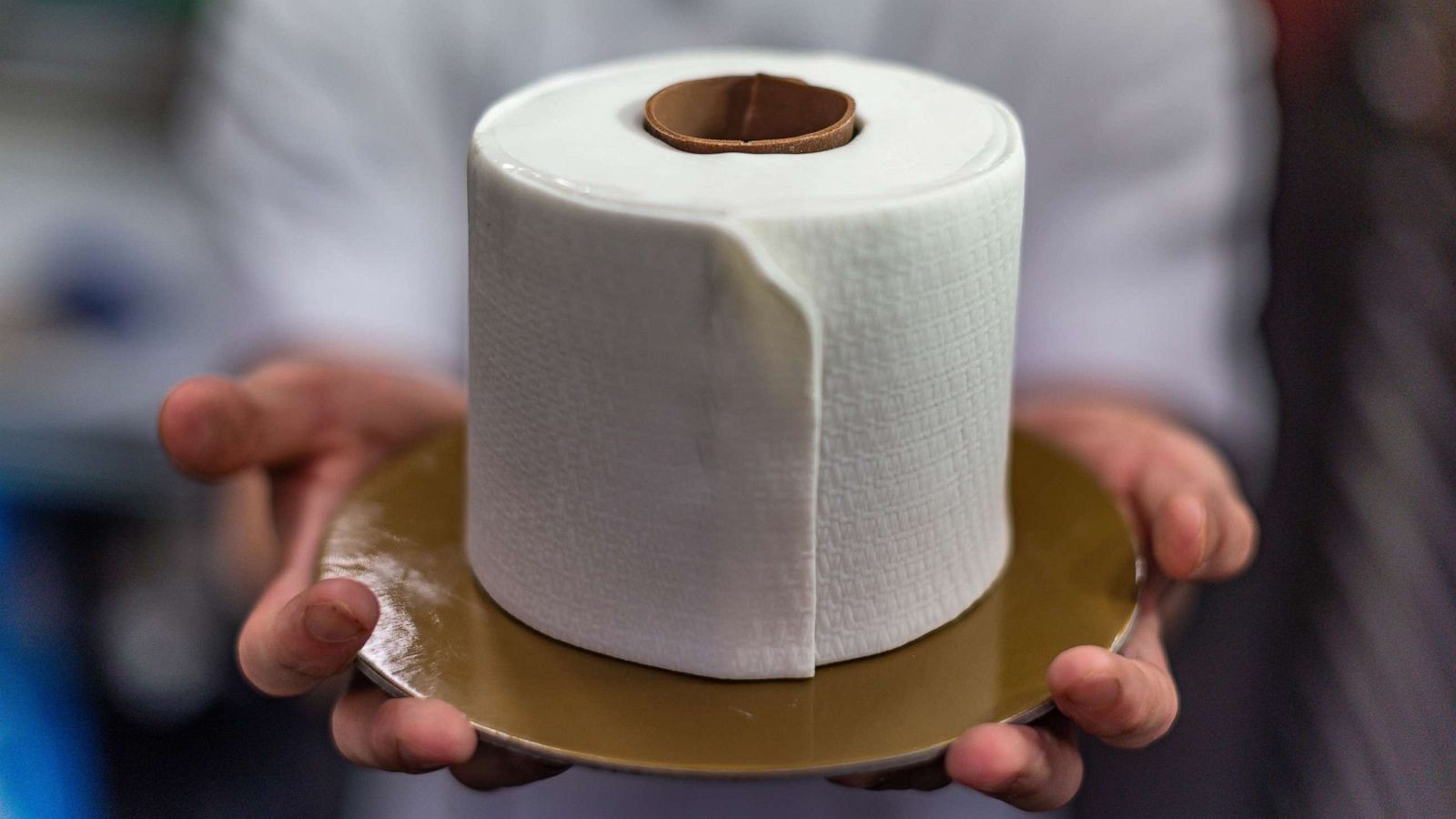 PHOTO: Pastry chef Gabriel Pang Yue Ken, 26, holds a cake designed to resemble a roll of toilet paper at the Le Pont Boulangerie cafe in Kuala Lumpur, June 4, 2020.