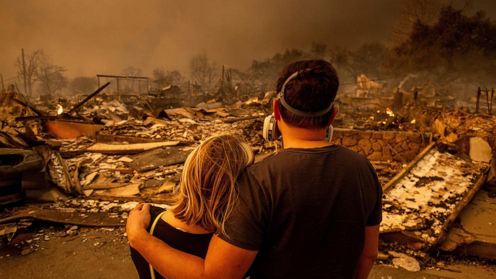 PHOTO: Megan Mantia, left, and her boyfriend Thomas, return to Mantia's fire-damaged home after the Eaton Fire swept through, Jan. 8, 2025, in Altadena, Calif.