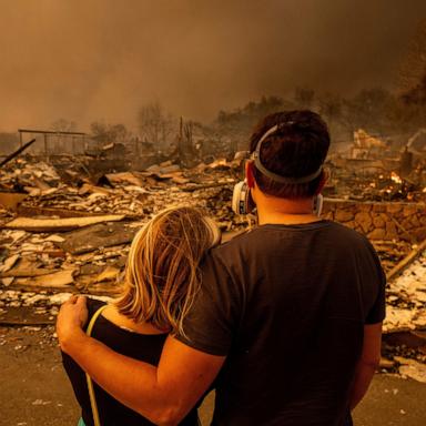 PHOTO: Megan Mantia, left, and her boyfriend Thomas, return to Mantia's fire-damaged home after the Eaton Fire swept through, Jan. 8, 2025, in Altadena, Calif.