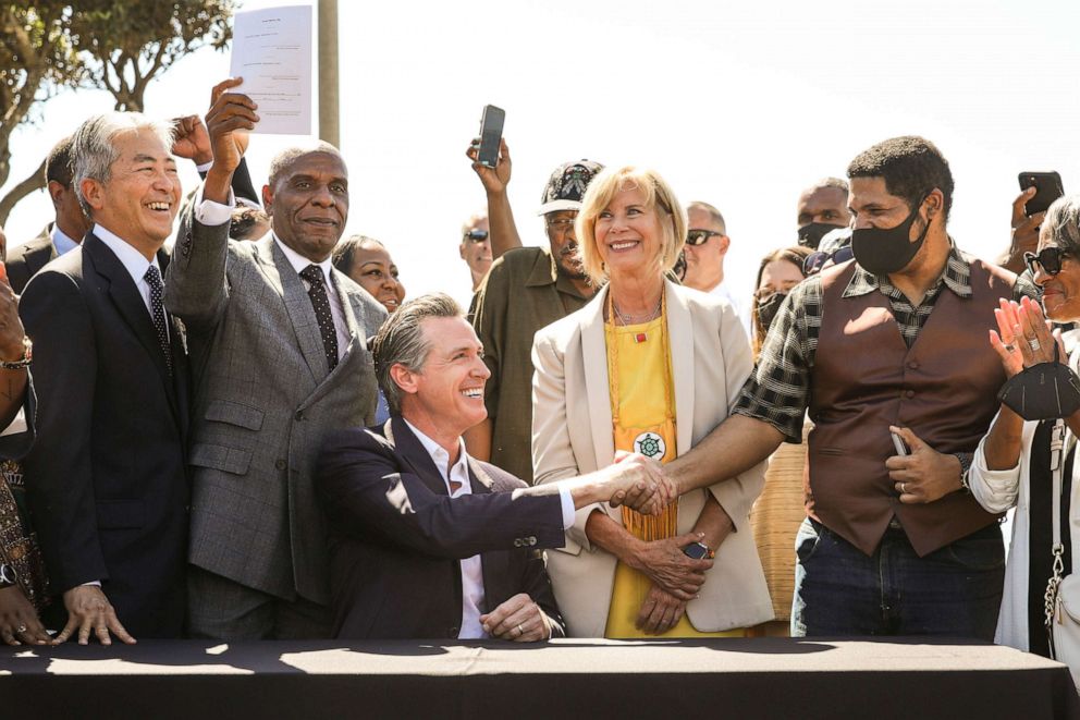 PHOTO: In this Sept. 30, 2021, file photo, Gov. Gavin Newsom shakes the hand of Anthony Bruce after signing the SB 796, authorizing the return of ocean-front land to the Bruce family, during a press conference at Bruce's Beach in Manhattan Beach, Calif.